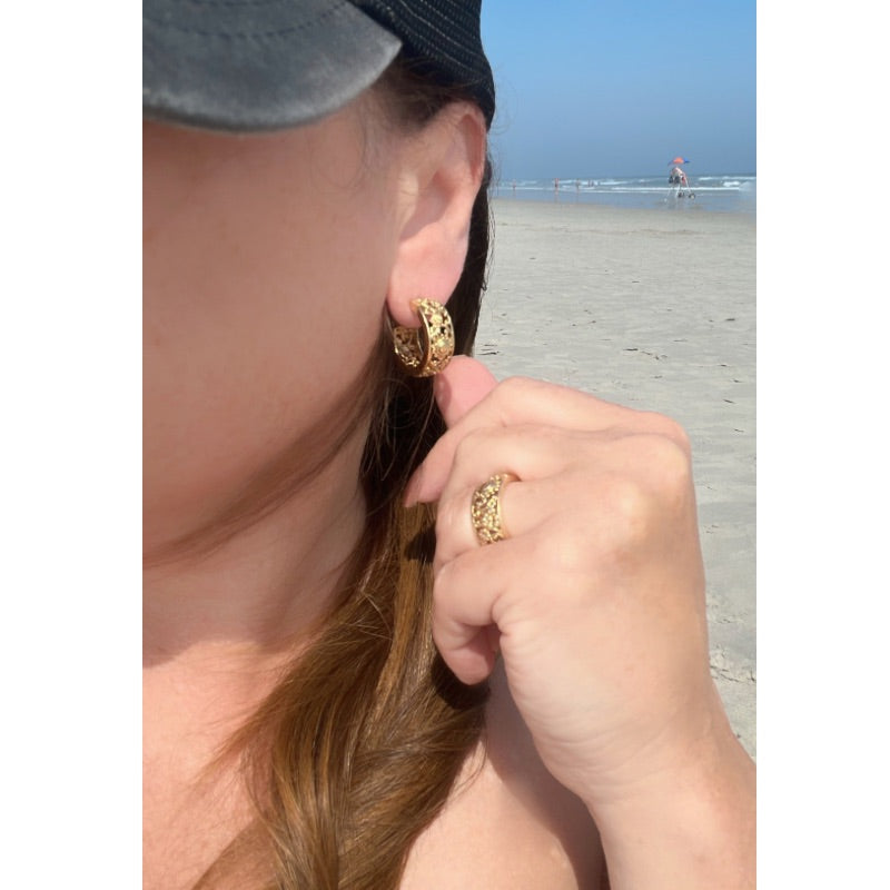 Goddess Scroll Hoop gold earrings and a ring with a beach background