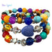 Colorful beaded bracelet with a blue stone on a white background, featuring the brand 'Free Spirit'.