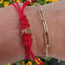 Goddaughters gold AngelEyes Heart Red String Bracelet with tulip logo hangtag 