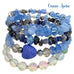 Stack of blue beaded bracelets with a blue stone heart on a white background, labeled 'Ocean Aura'.